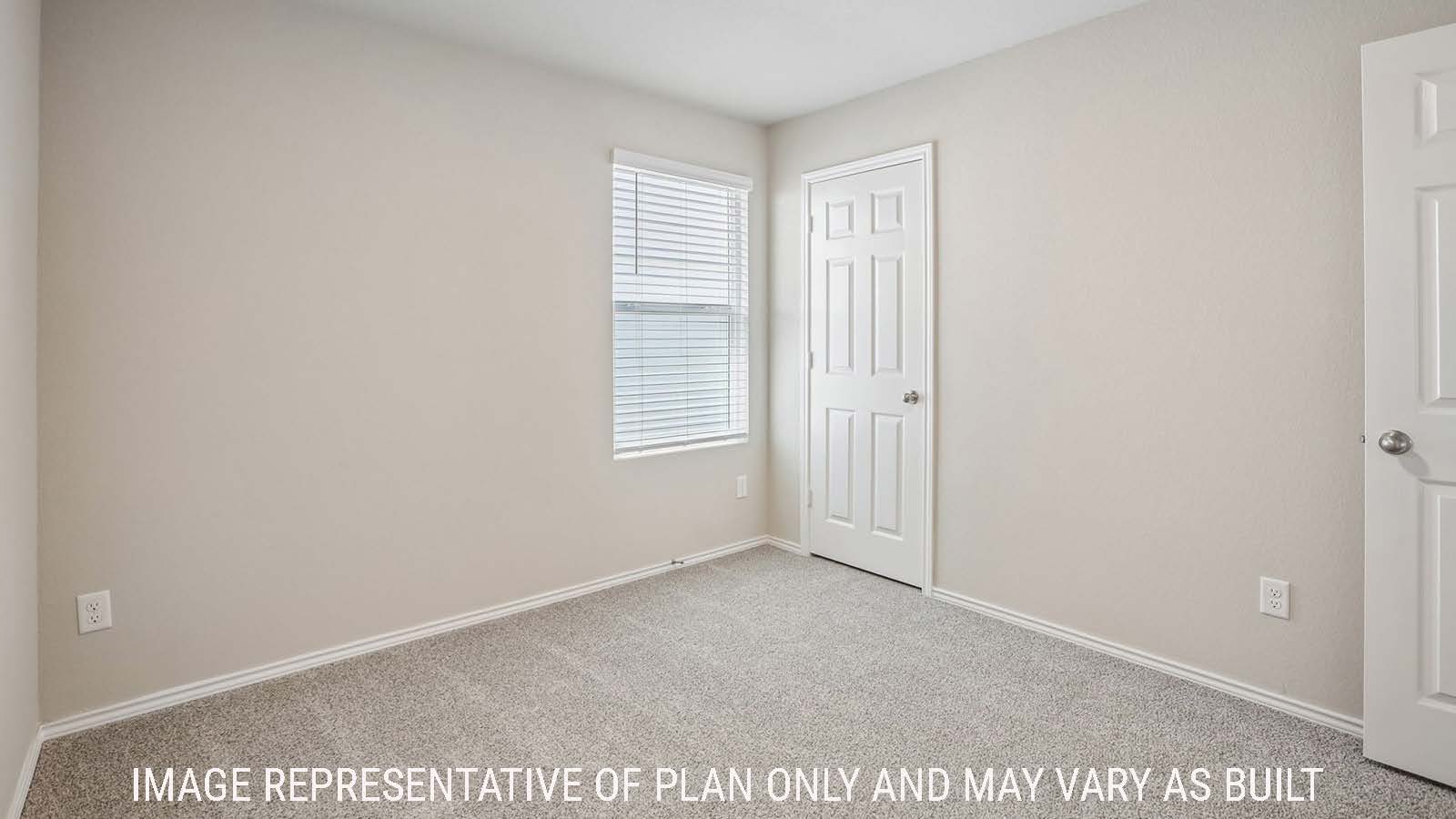 Bradley secondary bedroom with carpeted flooring and window for natural lighting.