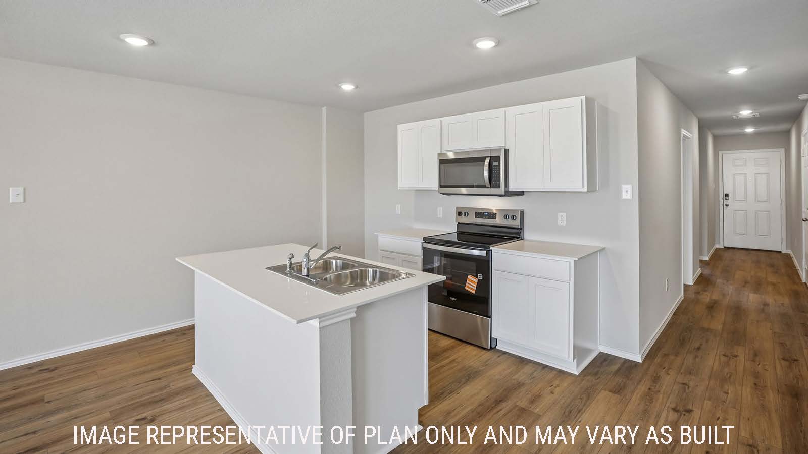 Bradley kitchen with view of kitchen island with light cabinets and view of entry hallway.