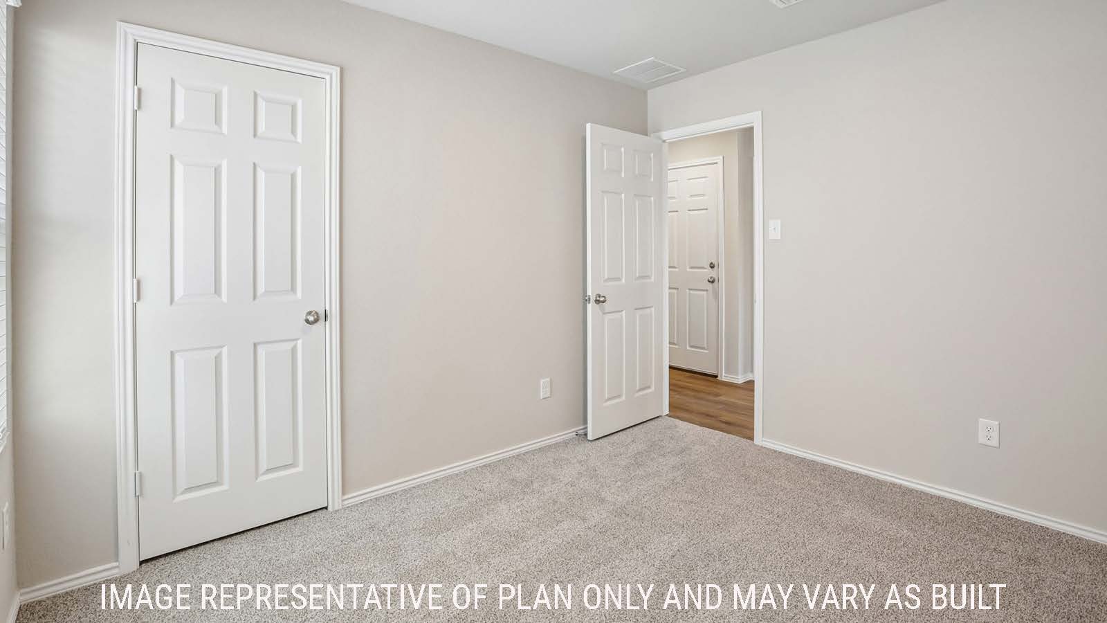 Bradley secondary bedroom with carpeted flooring and view of hallway.