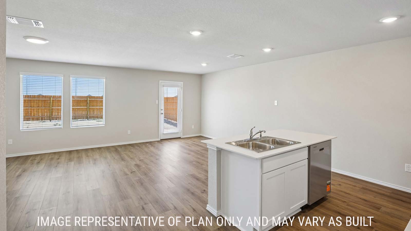 Bradley kitchen with kitchen island and view of open concept dining room and living room.