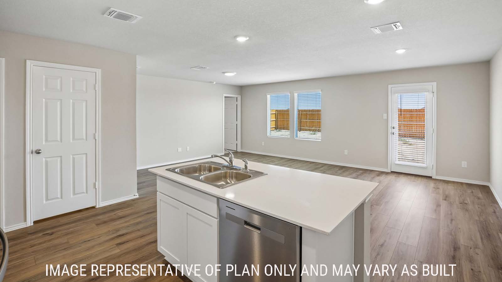Bradley kitchen with kitchen island and view of open concept dining room and living room.
