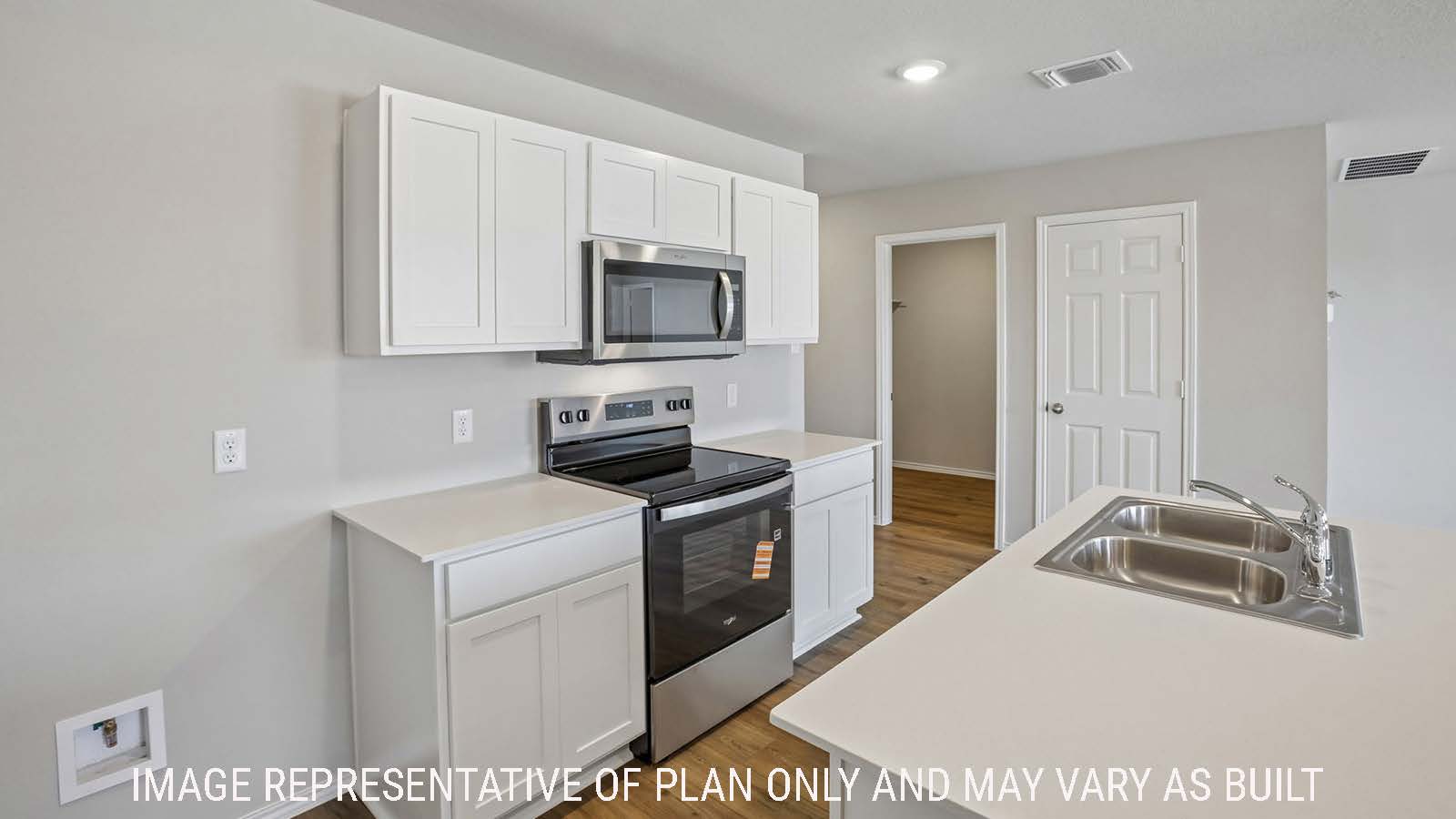 Bradley kitchen with kitchen island and white cabinets and granite countertops.
