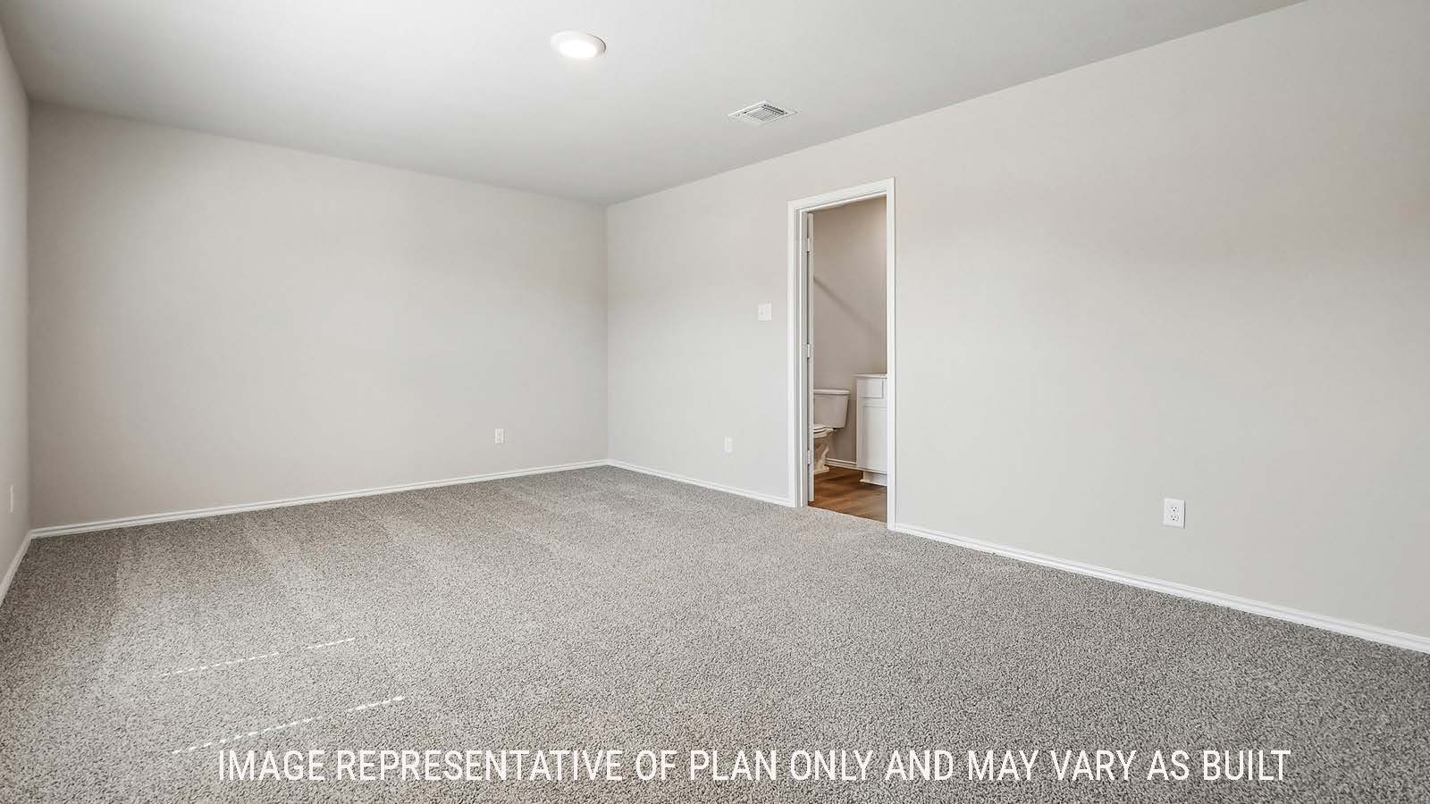 Callahan primary bedroom with carpeted flooring and view of primary bathroom.