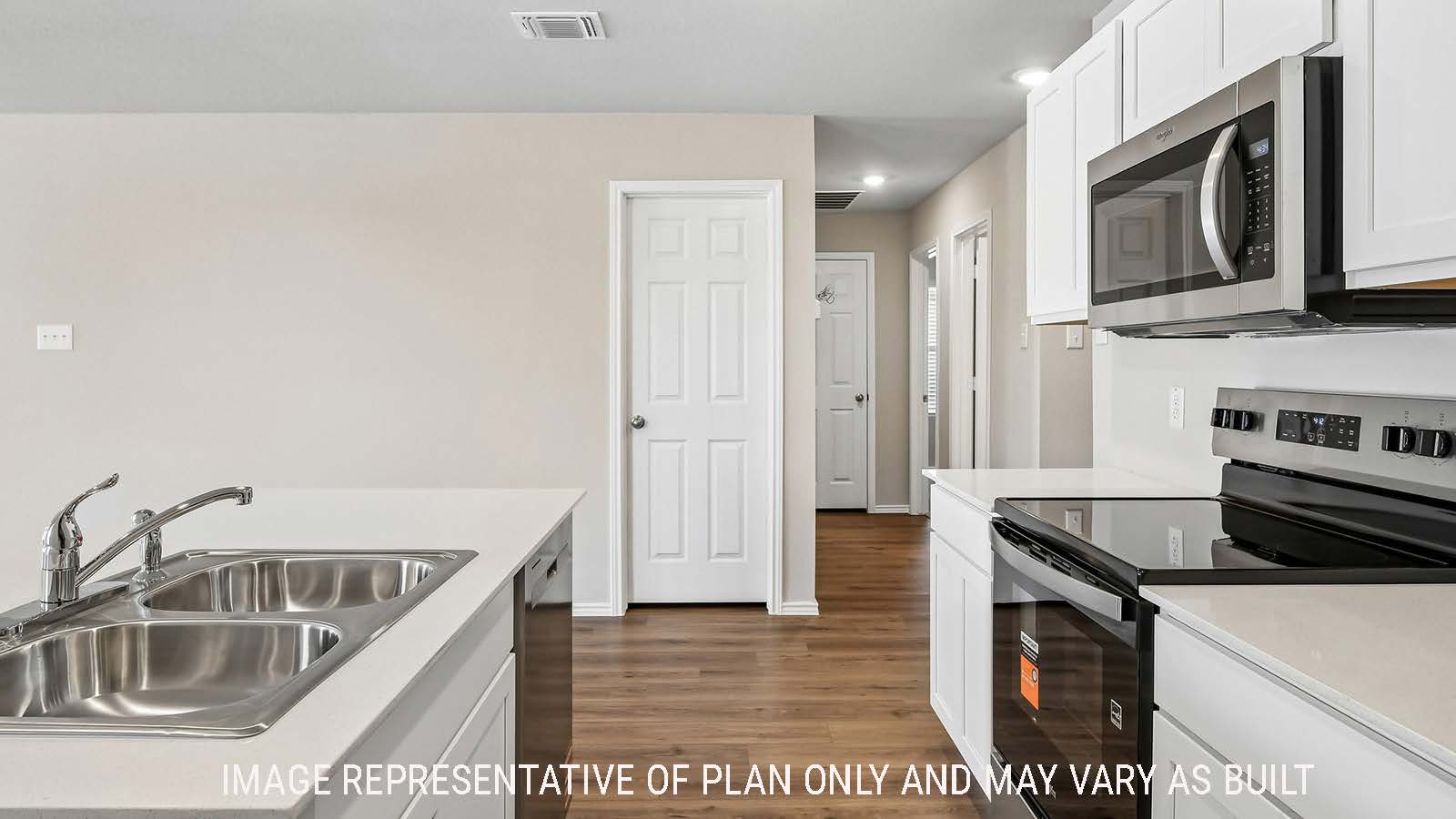 Callahan kitchen with kitchen island  with light cabinets and granite countertops.