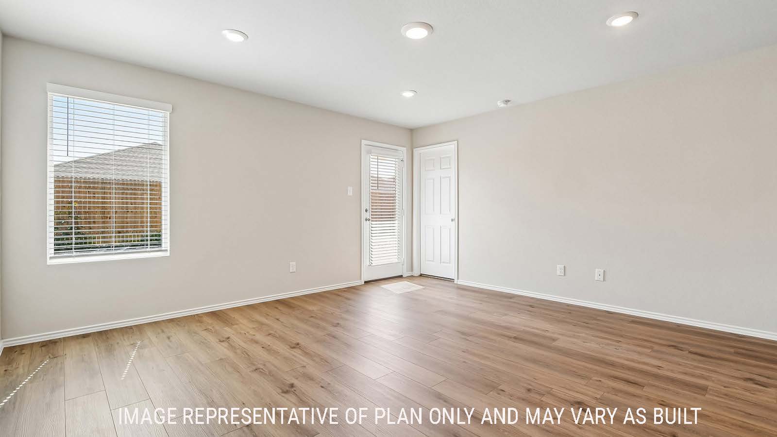 Callahan living room with windows for natural lighting and view of backyard.