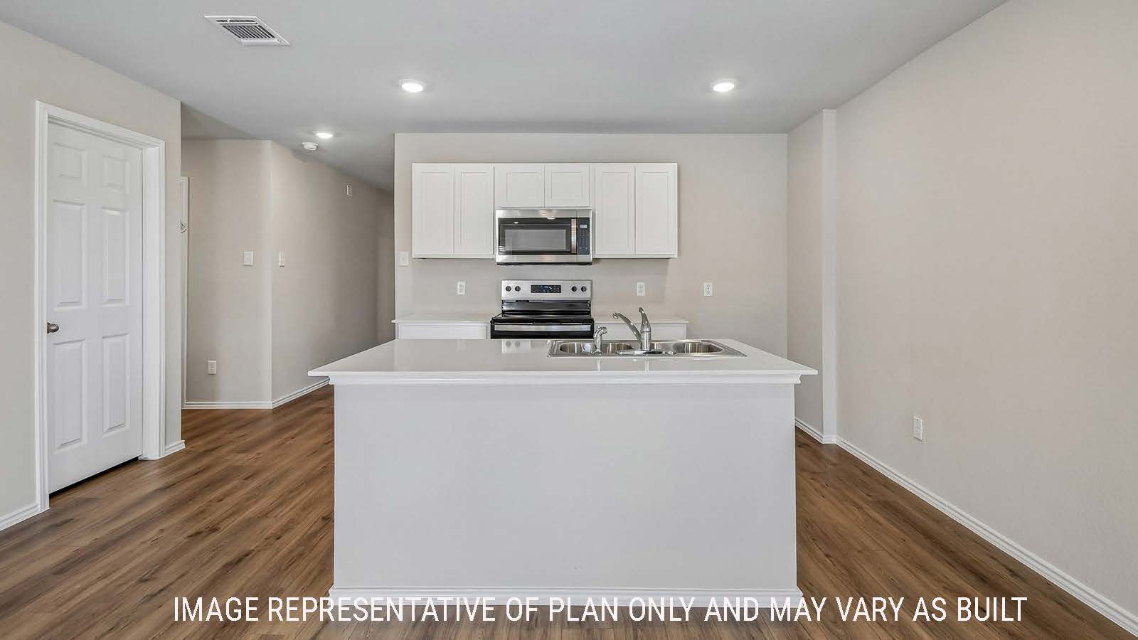 Callahan kitchen with kitchen island  with light cabinets and granite countertops.