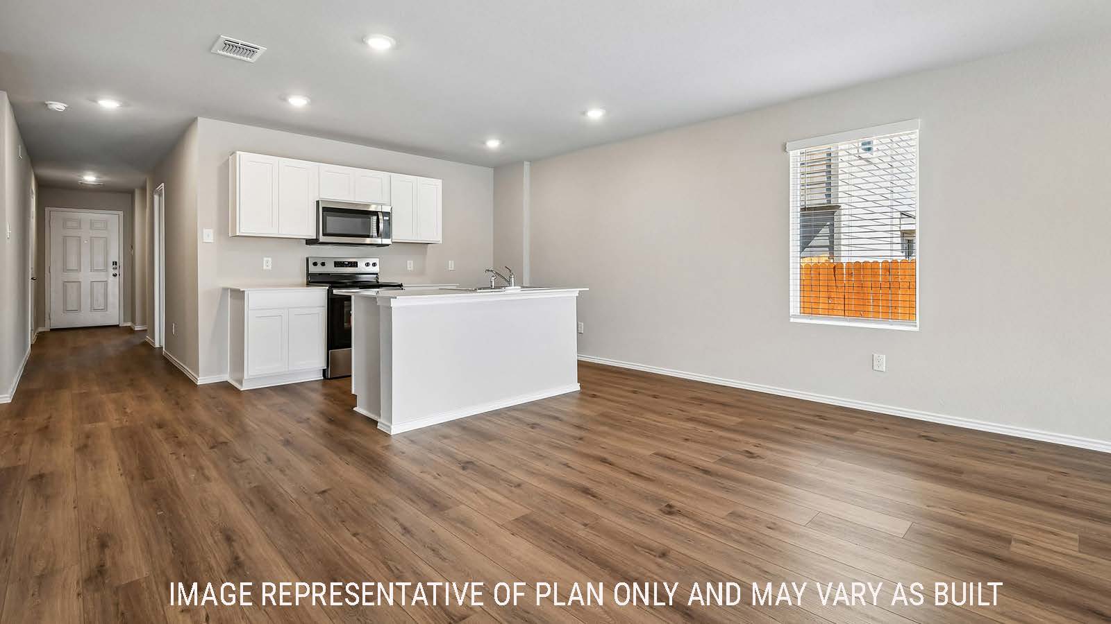 Callahan dining room with view of open concept kitchen and hallway to the entry door.