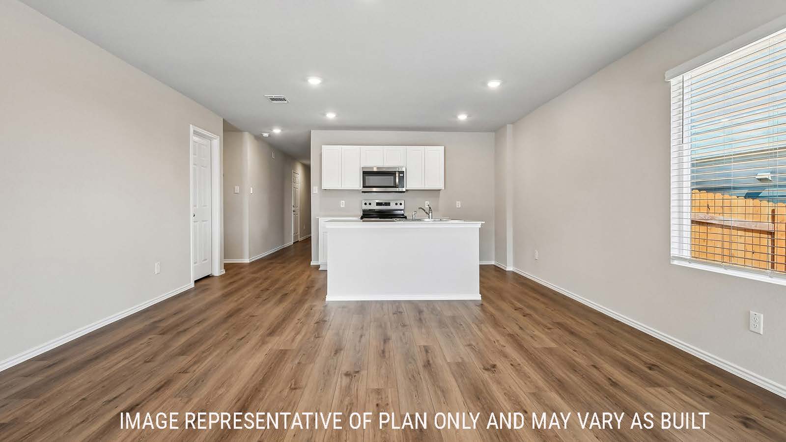 Callahan dining room with view of open concept kitchen and window for natural lighting.