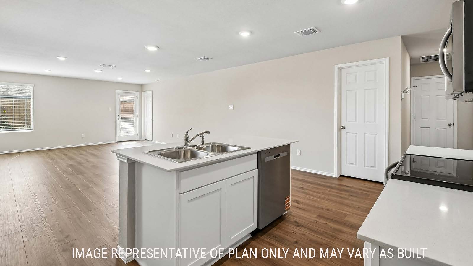 Callahan kitchen with kitchen island  with light cabinets and granite countertops.