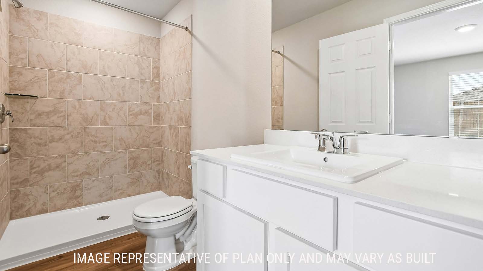 Callahan primary bathroom with vanity sink and walk-in shower.