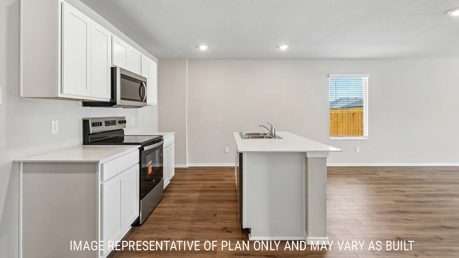 Callahan kitchen with kitchen island  with light cabinets and granite countertops.