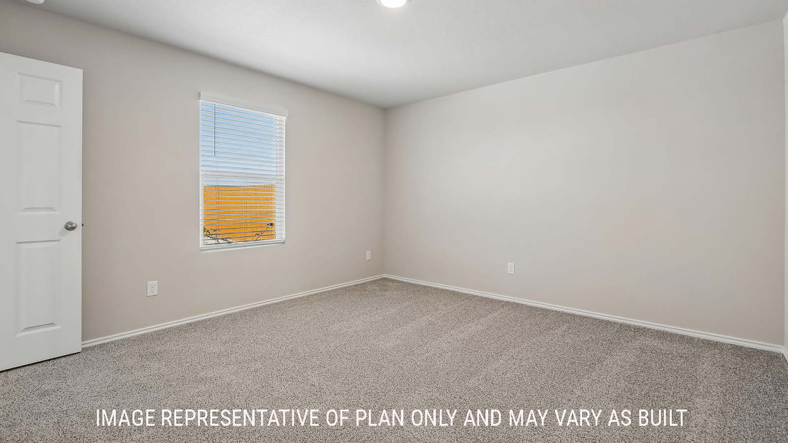 Austin primary bedroom with carpeted flooring and window for natural lighting.