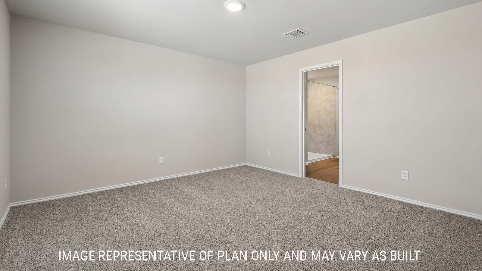 Austin primary bedroom with carpeted flooring and view of primary bathroom.