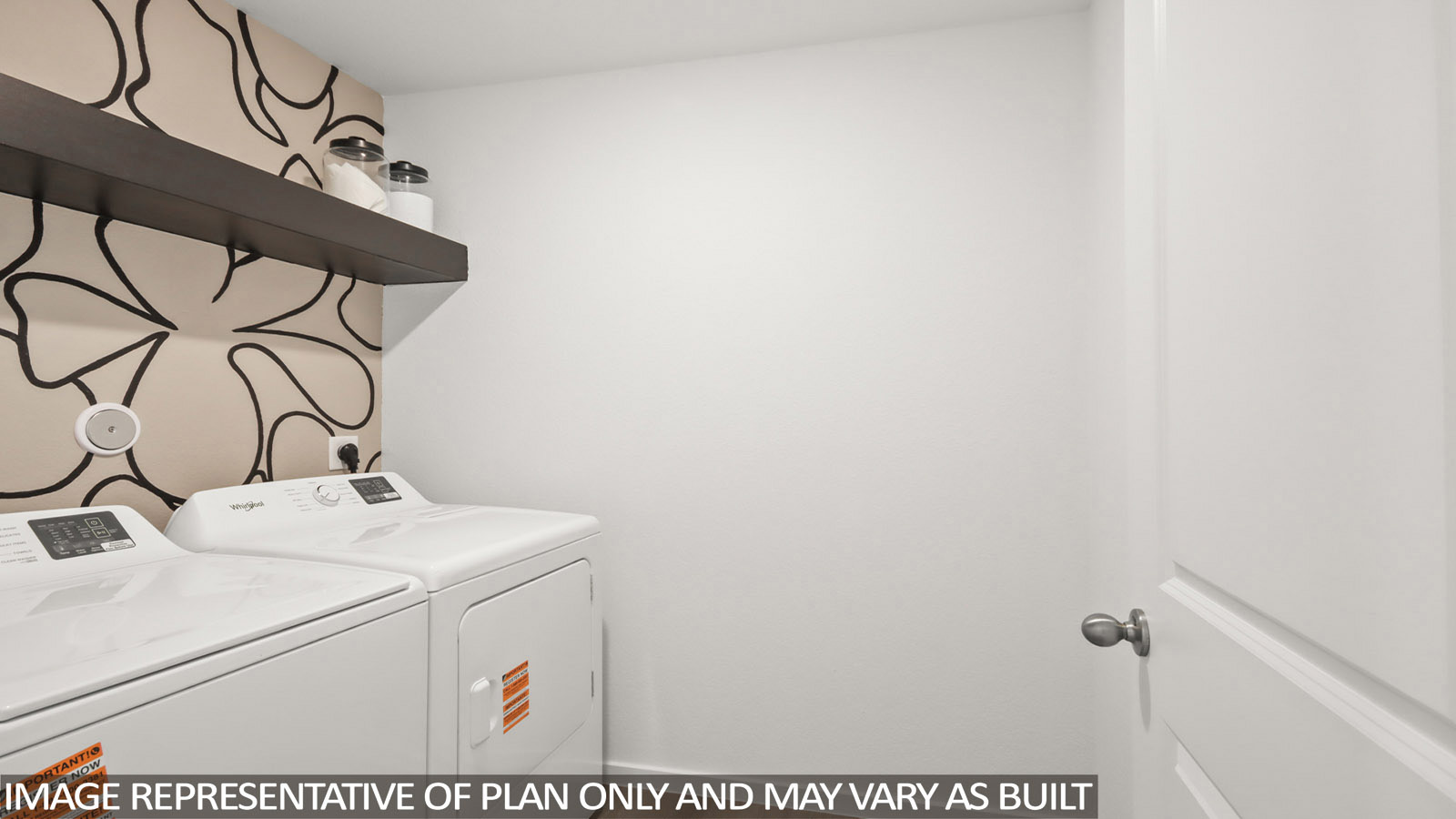 Austin utility room with washer and dryer and shelving for storage.