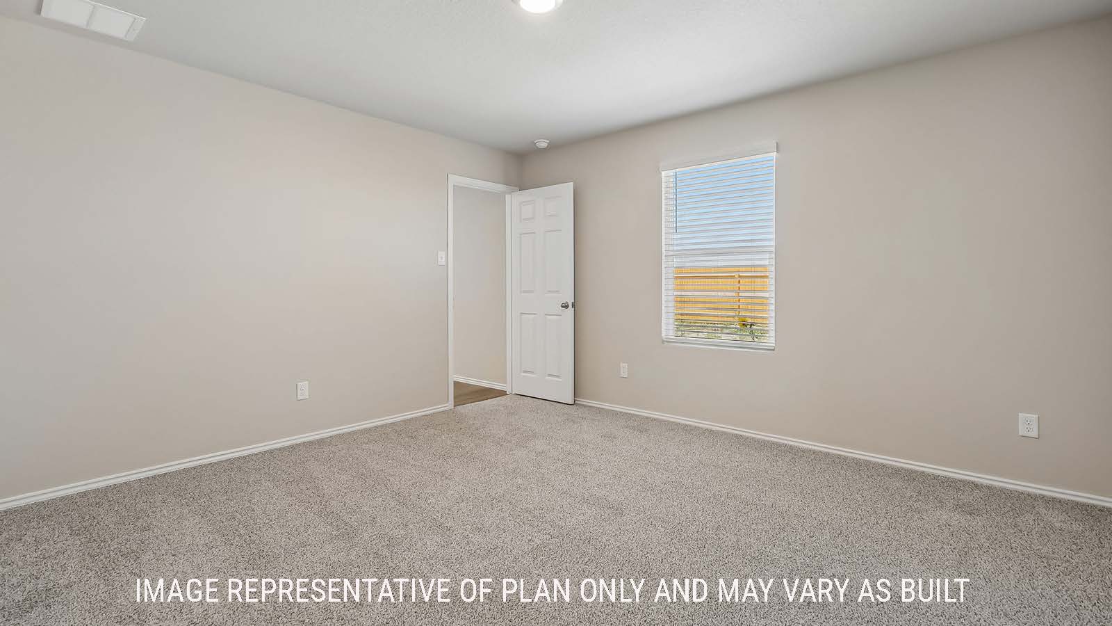Austin primary bedroom with carpeted flooring and window for natural lighting.