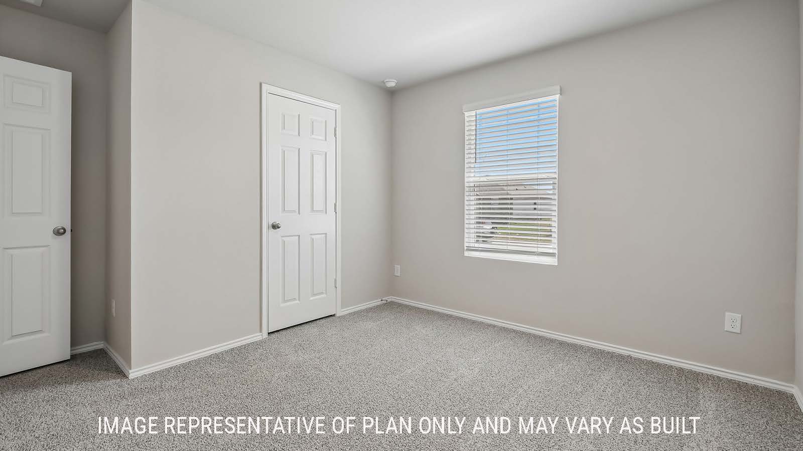 Austin secondary bedroom with carpeted flooring and window for natural lighting.