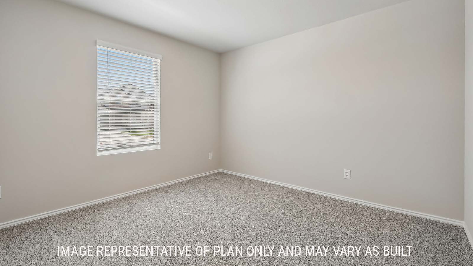 Austin secondary bedroom with carpeted flooring and window for natural lighting.