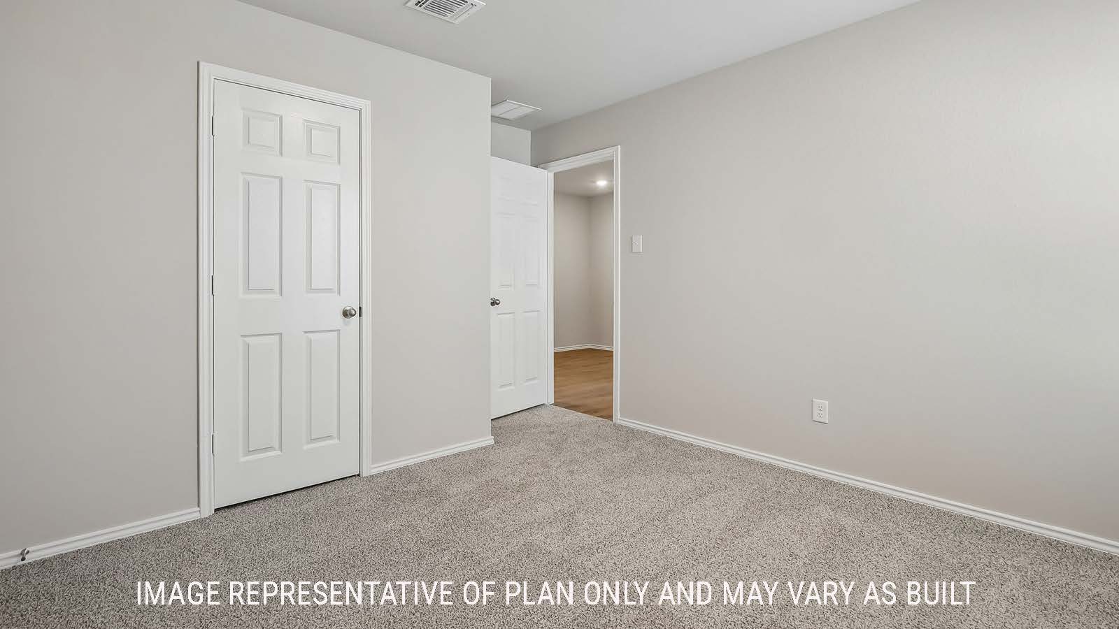 Austin secondary bedroom with carpeted flooring and view of closet door.