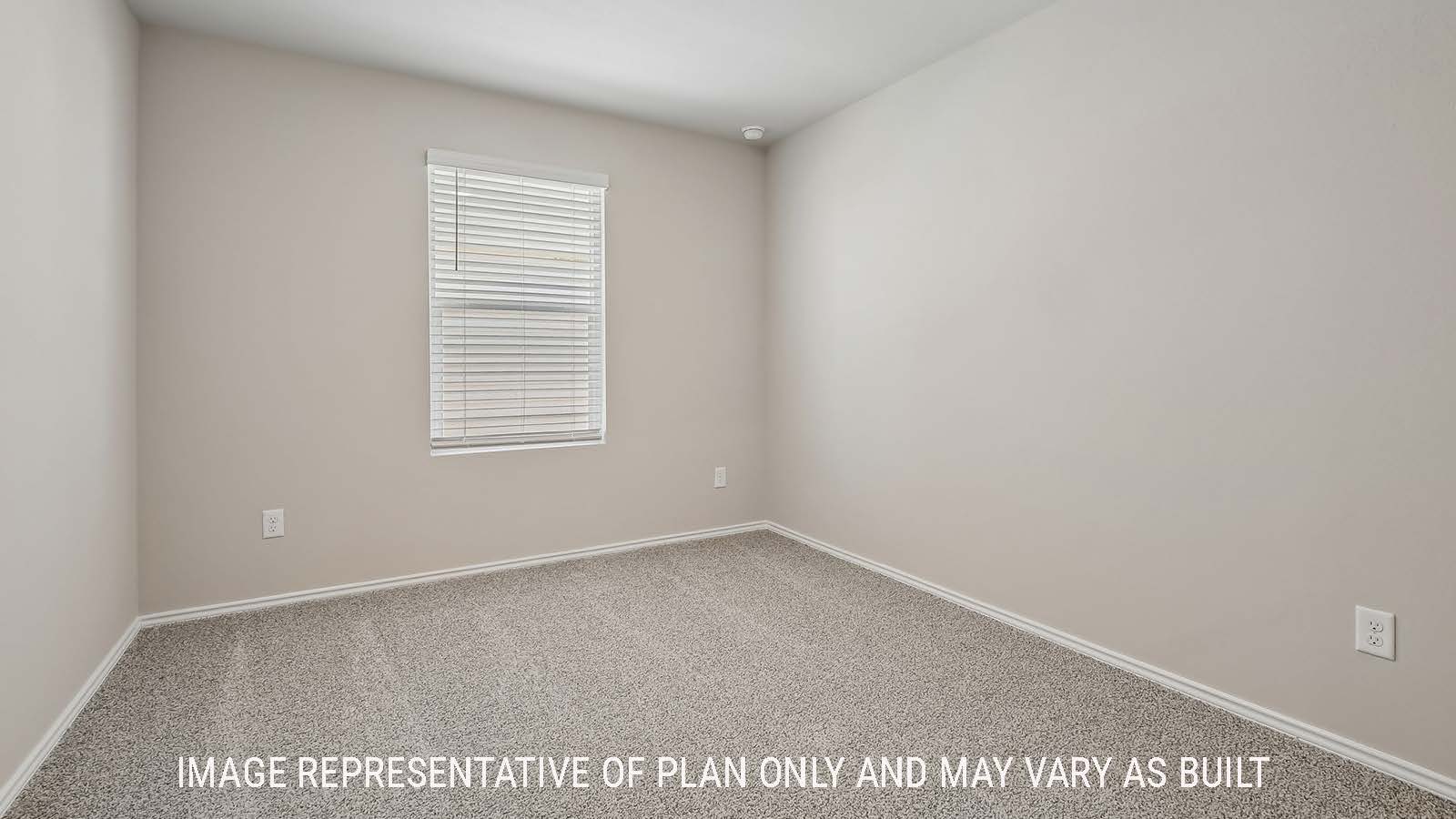 Austin secondary bedroom with carpeted flooring and window for natural lighting.