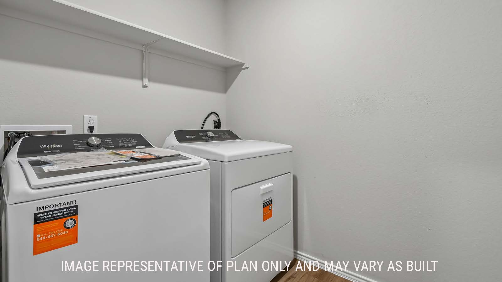 Austin utility room with washer and dryer and shelving for storage.