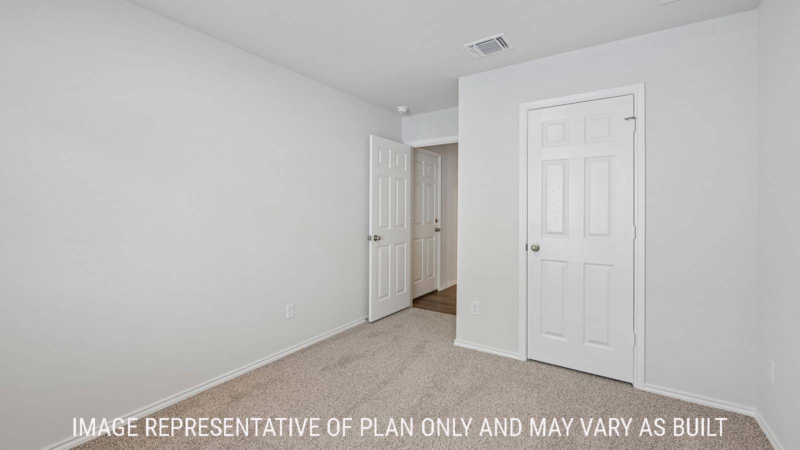 Baird secondary bedroom with carpeted flooring and view of hallway.