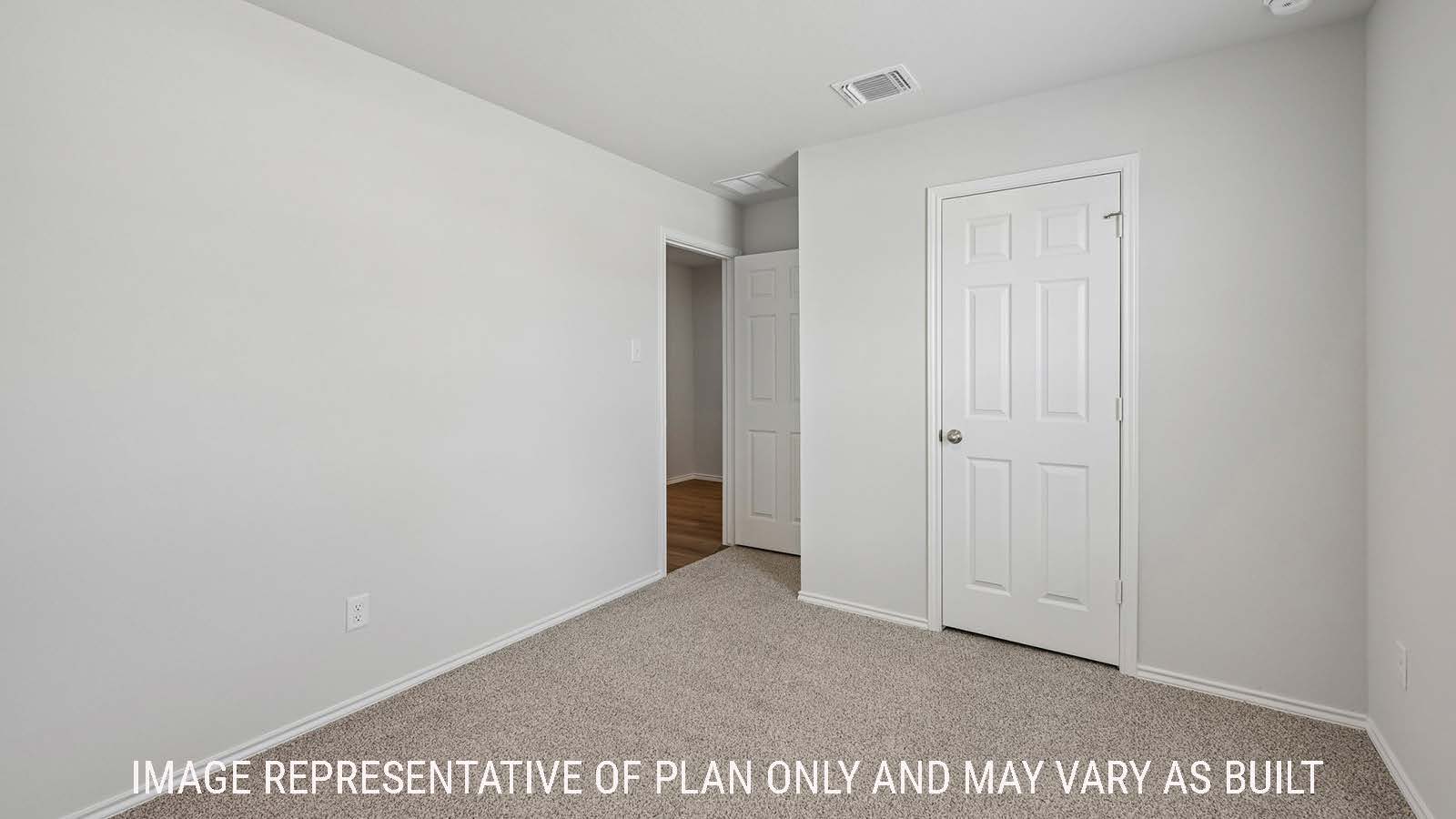 Baird secondary bedroom with carpeted flooring and view of hallway.