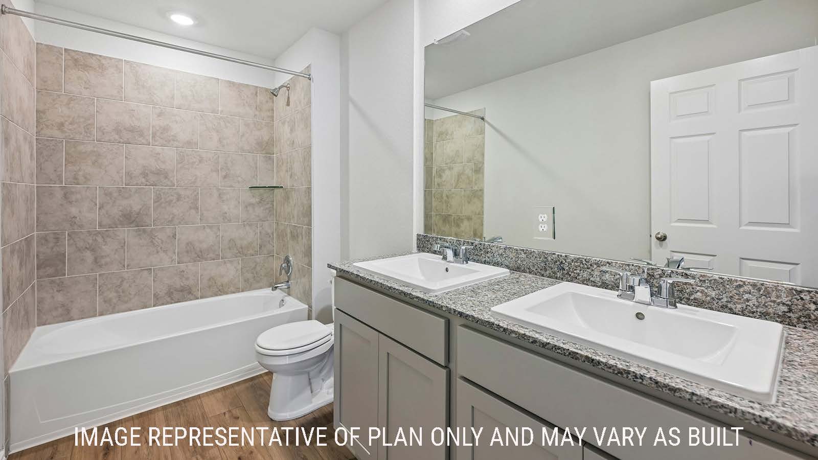 Baird secondary bathroom with double vanity sink and shower and tub combo.