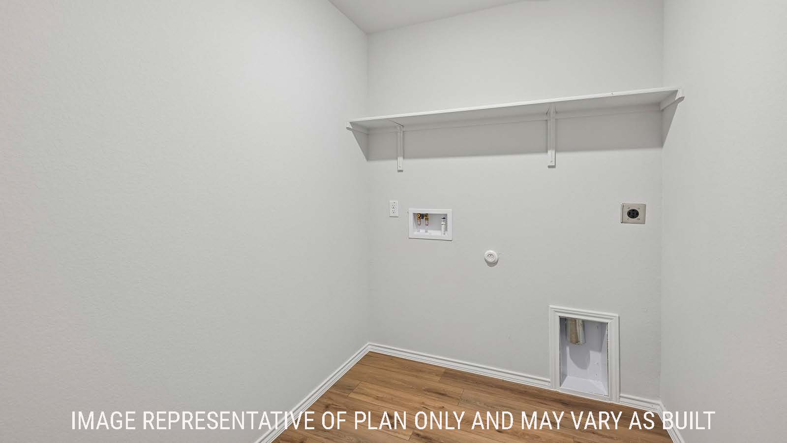 Baird utility room with washer and dryer connections and shelving for storage.