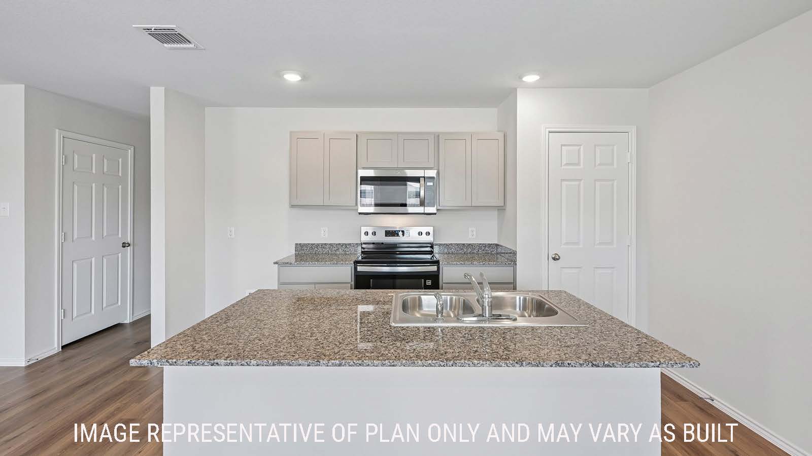 Baird kitchen with kitchen island with granite countertops and light cabinets.