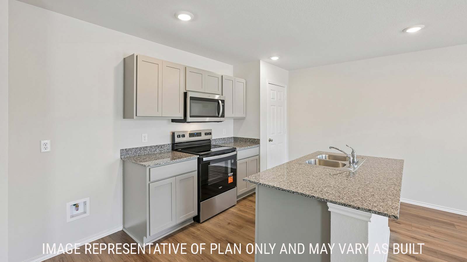 Baird kitchen with kitchen island with granite countertops and light cabinets.