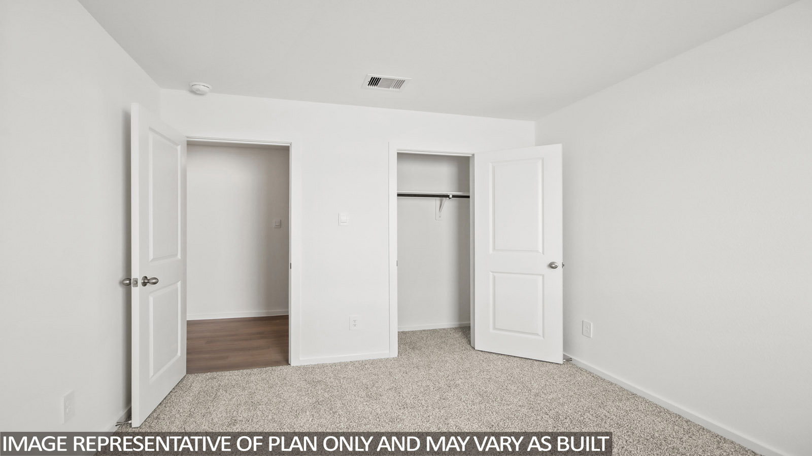 Baird secondary bedroom with carpeted flooring with view of hallway.