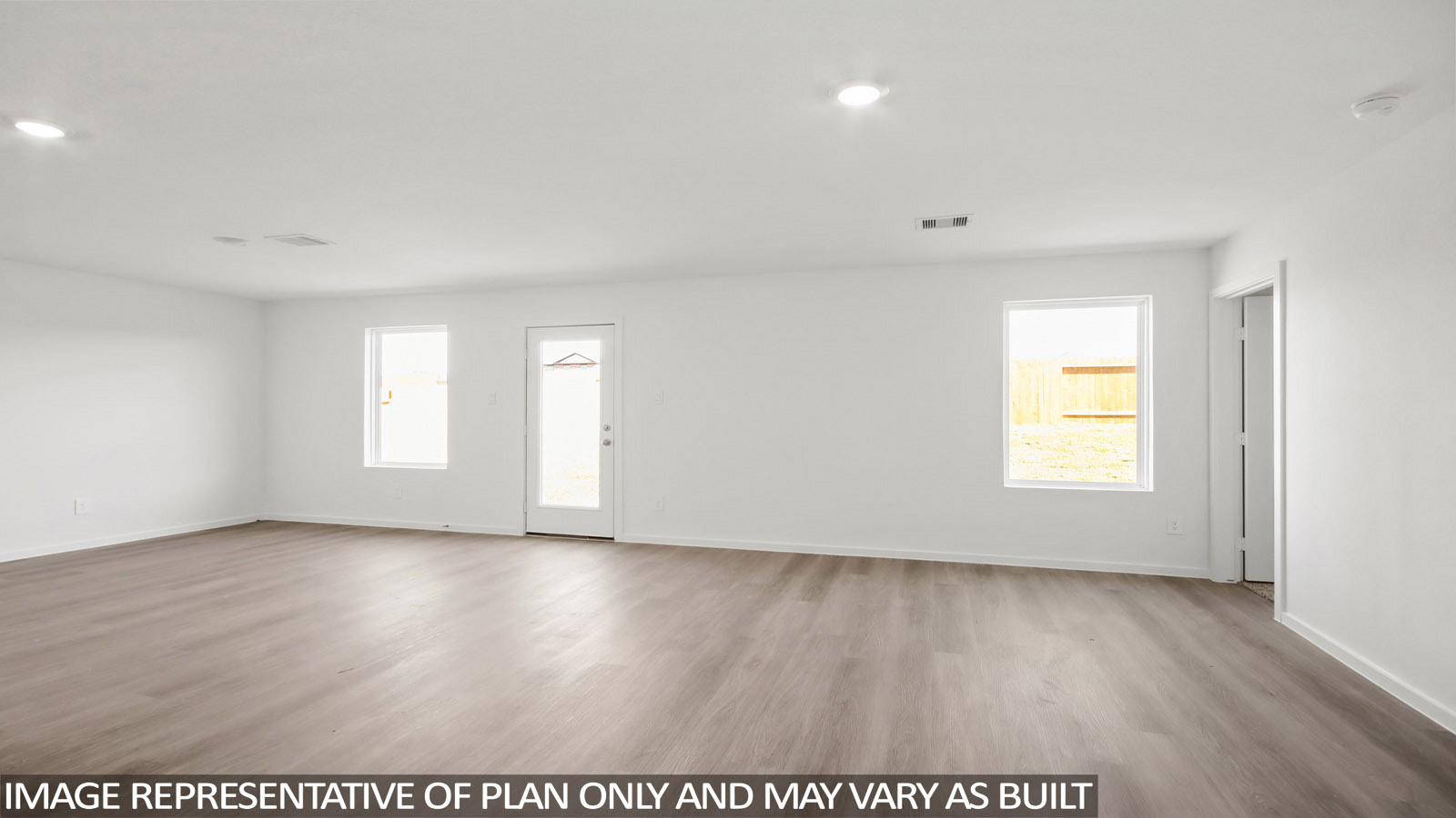 Baird living room with vinyl plank flooring and view of back door and back yard.