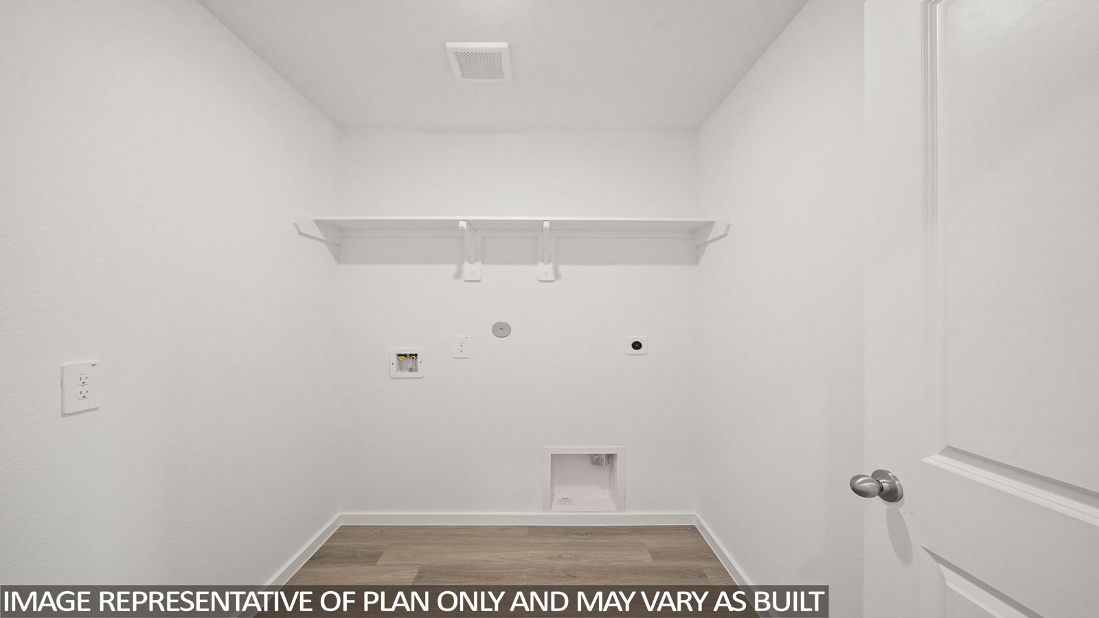 Cooper utility room with washer and dryer connections with shelving for storage.