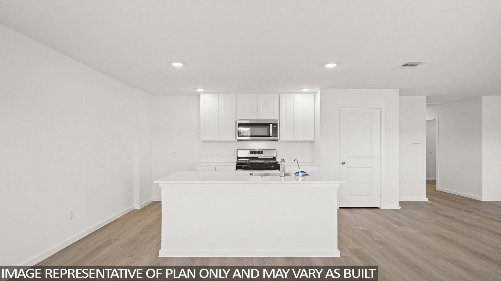 Cooper kitchen with kitchen island and light cabinets with light countertops and view of front entry.