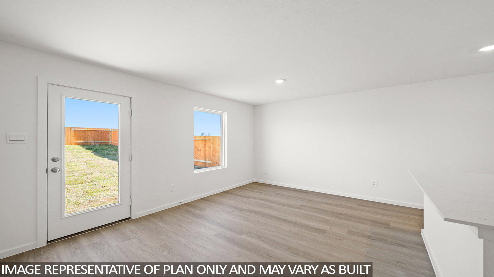 Cooper dining room with vinyl plank flooring and view of back door and back yard.