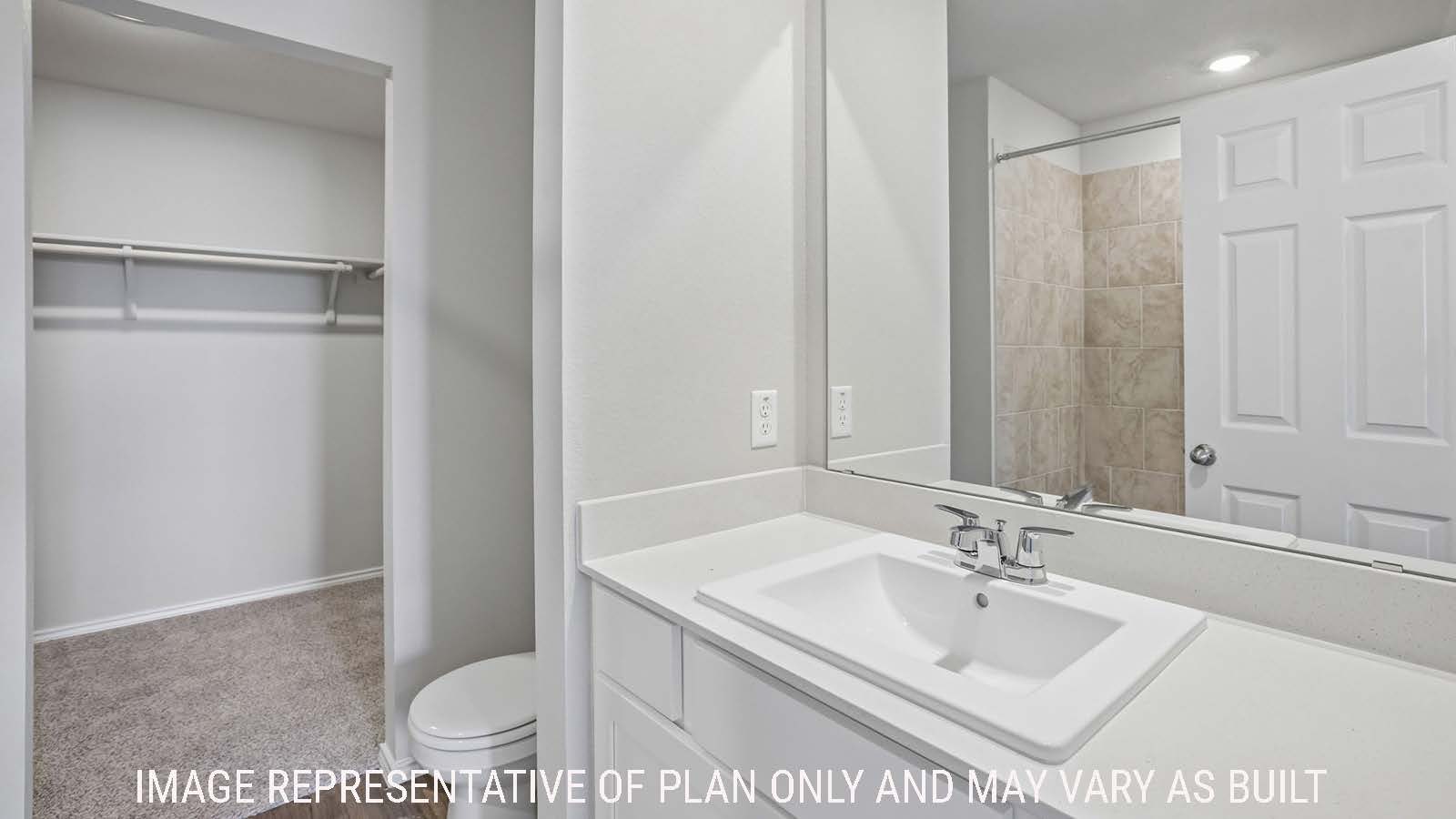 Cooper primary bathroom with vanity sink and view of walk-in shower and primary bedroom walk-in closet.
