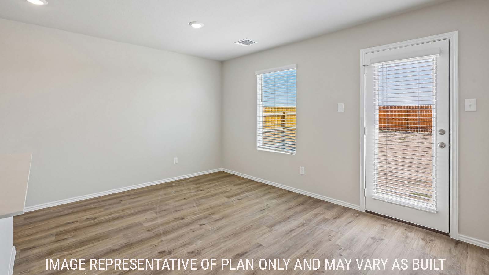 Cooper dining room wit view of back door to the backyard and windows for natural lighting.