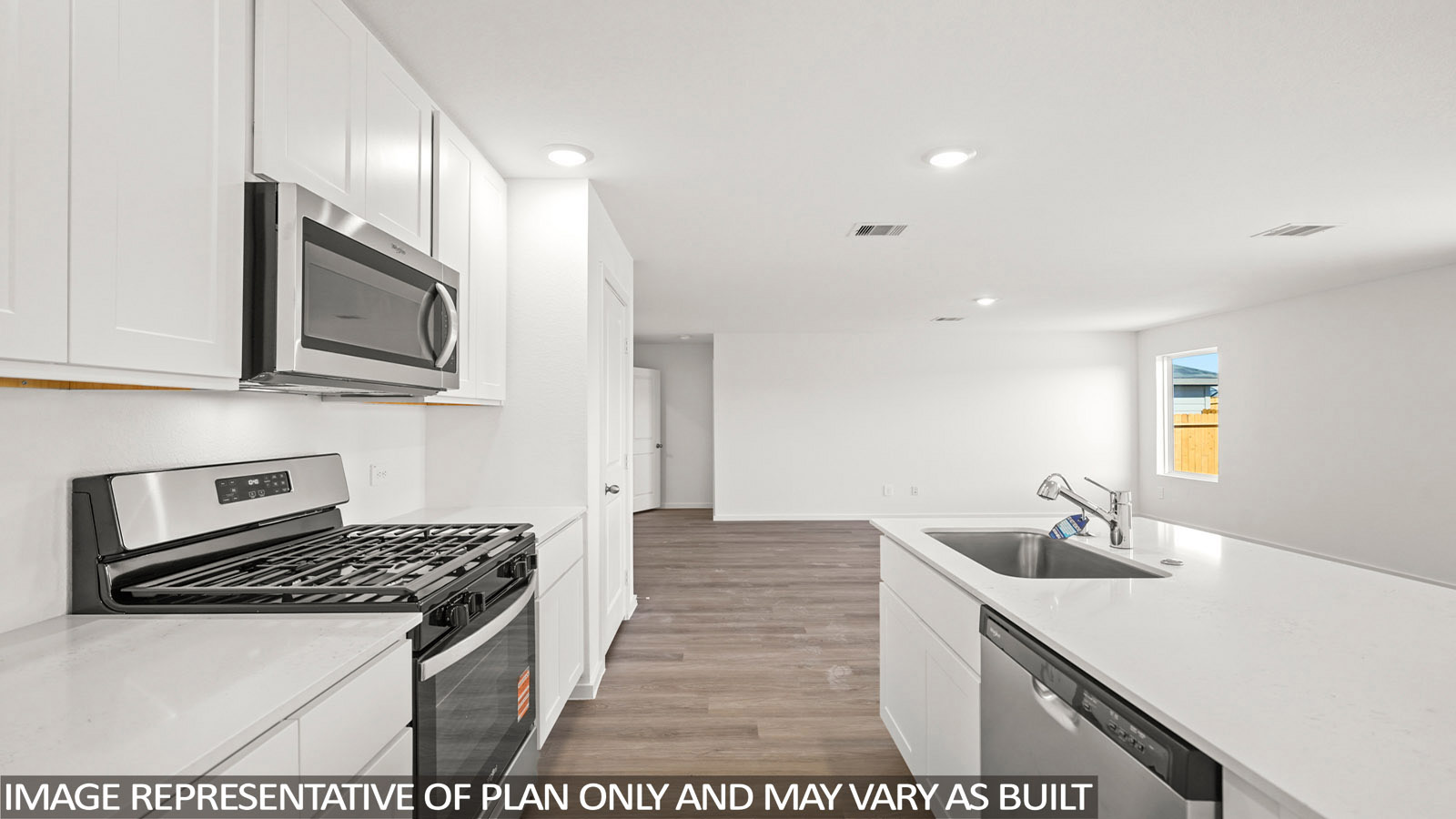 Cooper kitchen with kitchen island and light cabinets with light countertops with view of living room.