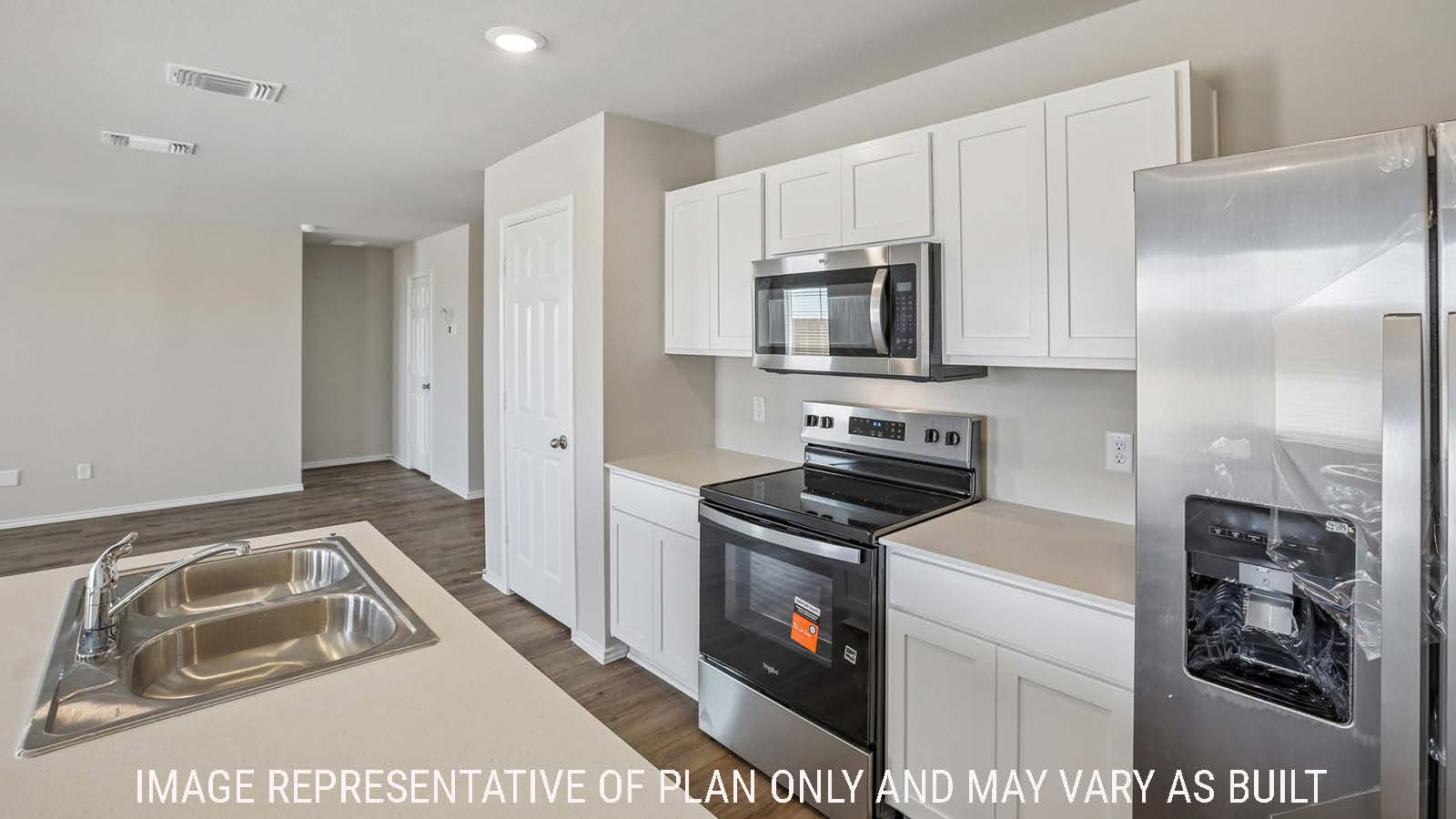 Cooper kitchen with kitchen island and white cabinets and granite countertops.