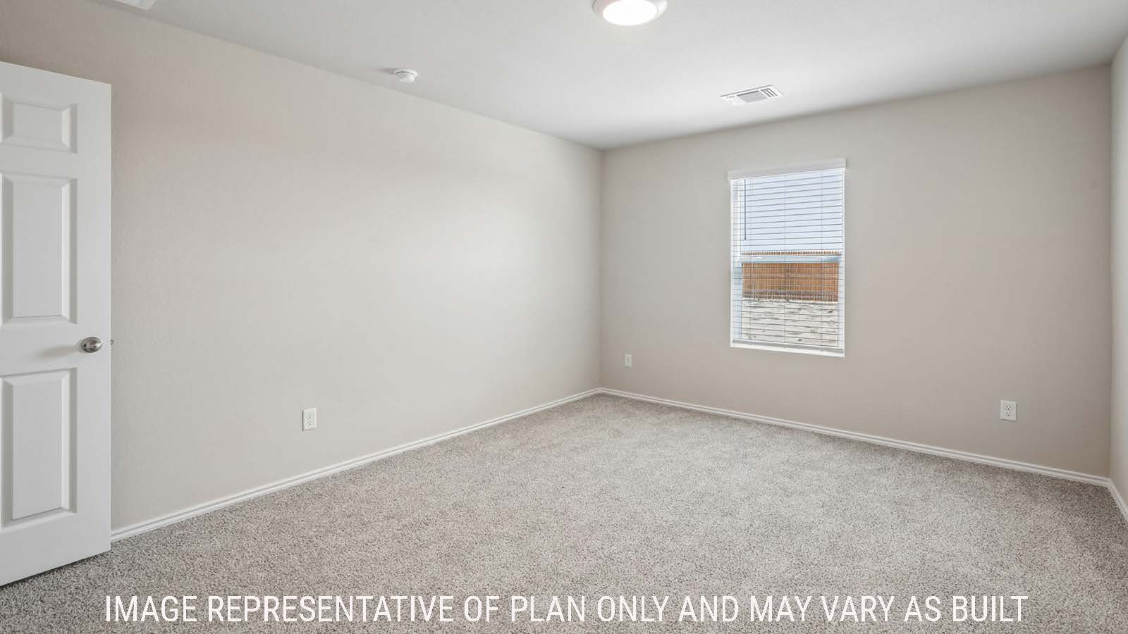 Cooper primary bedroom with carpeted flooring and window for natural lighting.