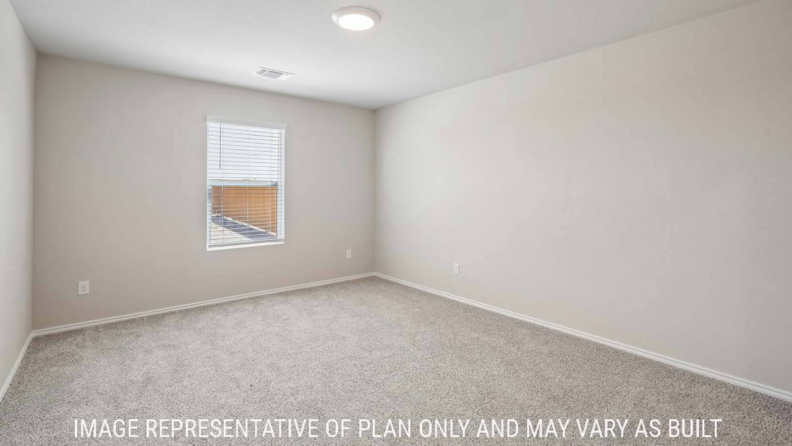 Cooper primary bedroom with carpeted flooring and window for natural lighting.