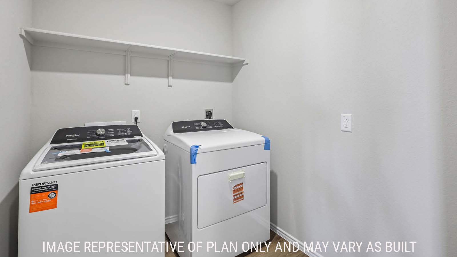 Cooper utility room with washer and dryer and shelving for storage.