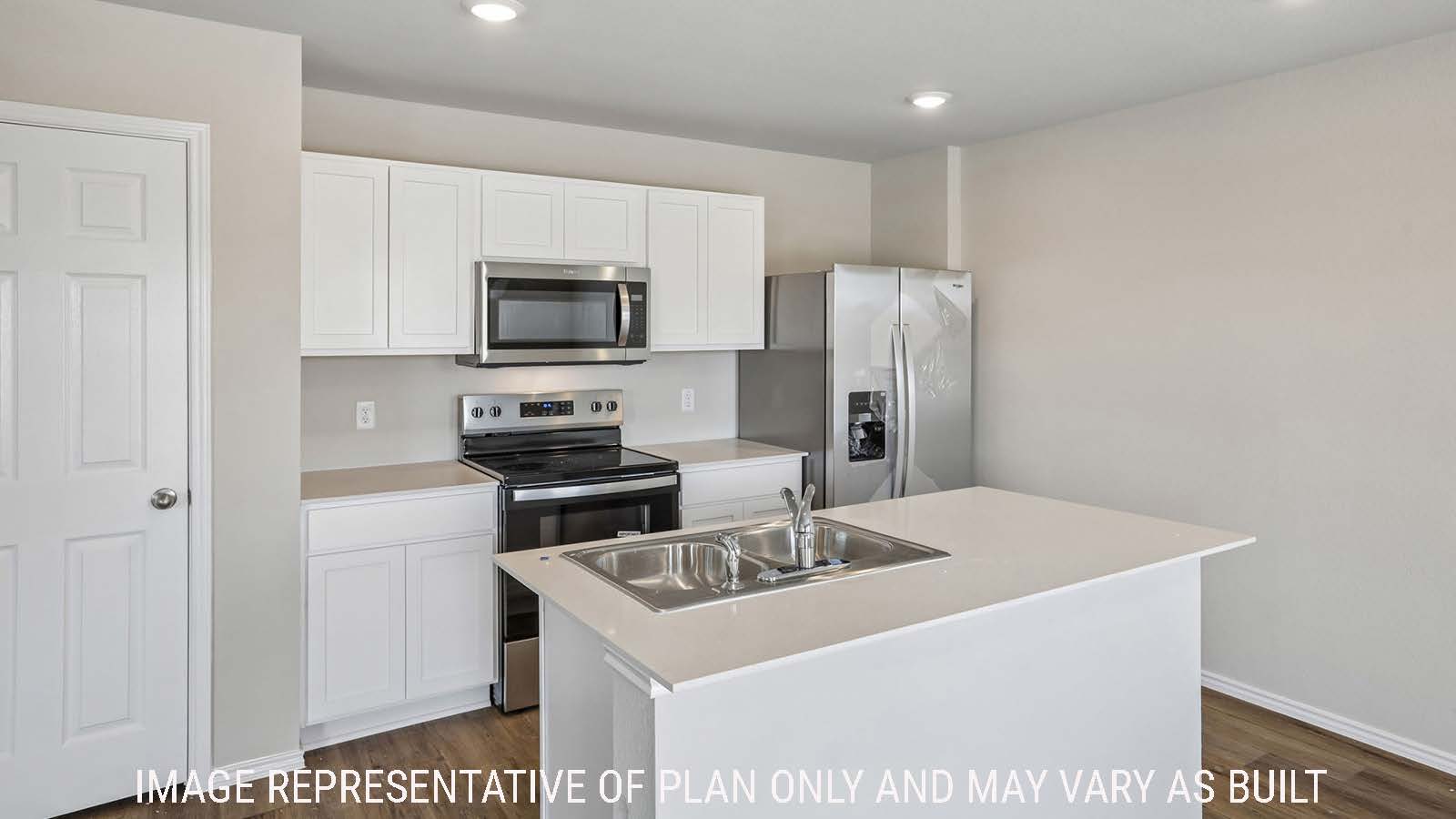 Cooper kitchen with kitchen island and white cabinets and granite countertops.