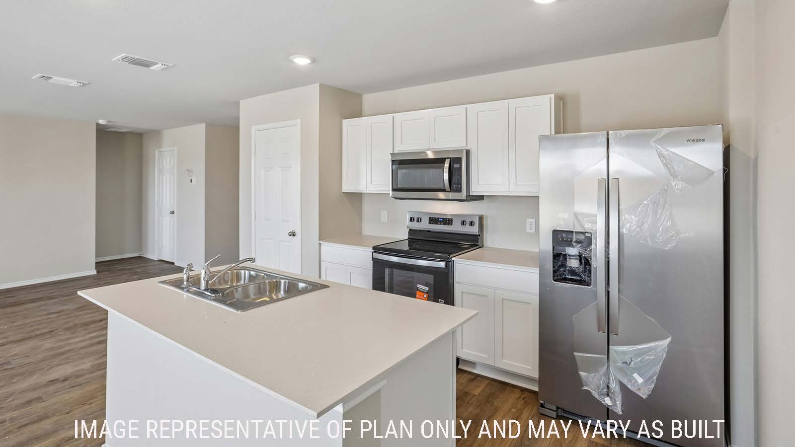 Cooper kitchen with kitchen island and white cabinets and granite countertops.