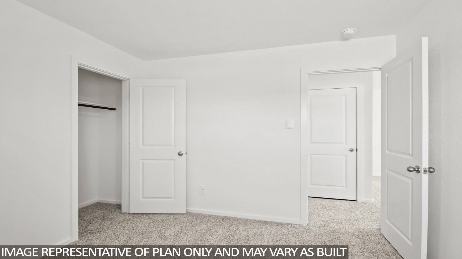 Denise secondary bedroom with carpeted flooring and view of hallway.