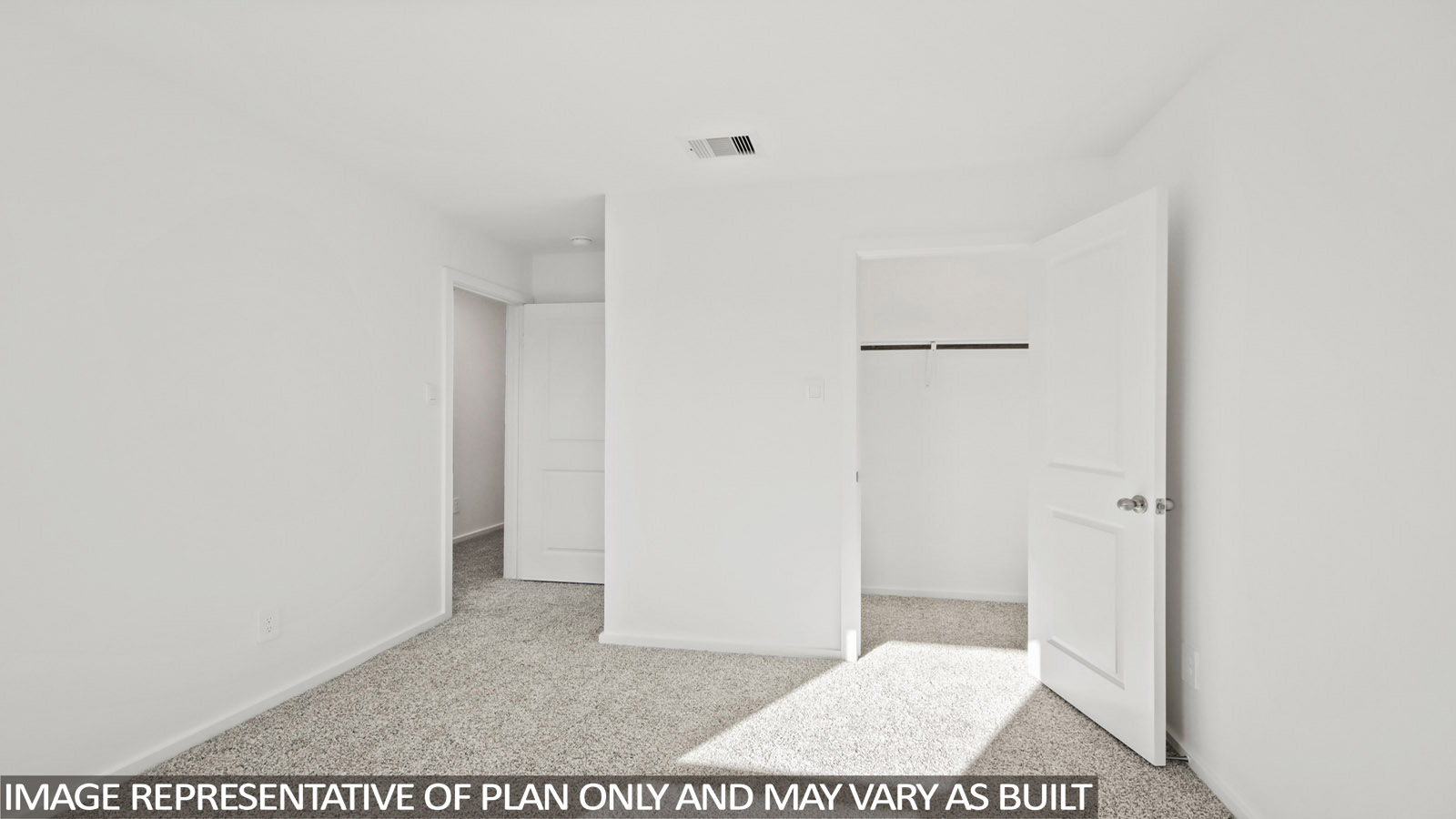 Denise secondary bedroom with carpeted flooring and view of hallway.