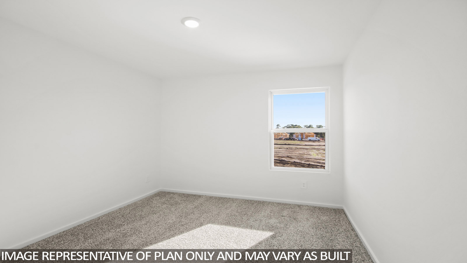 Denise secondary bedroom with carpeted flooring and window for natural lighting.