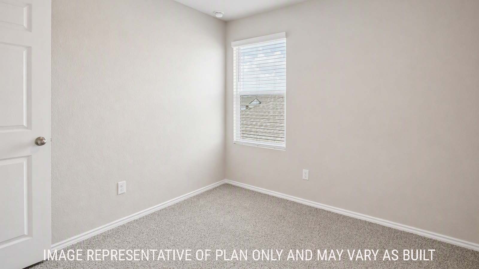 Denise secondary bedroom with carpeted flooring and windows for natural lighting.