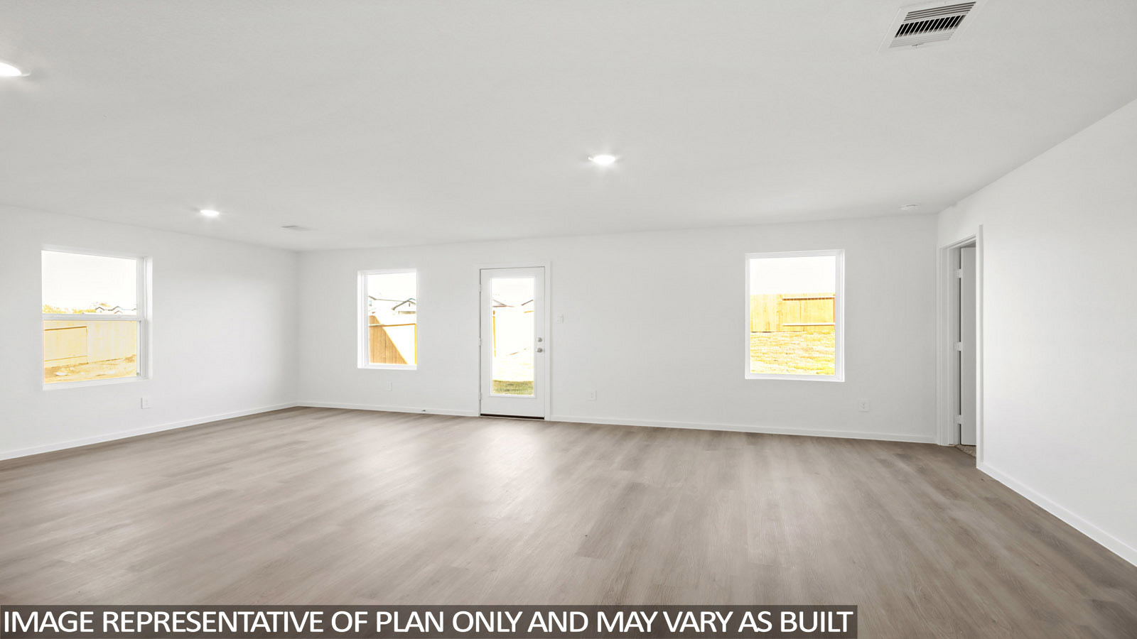 Denise living room with vinyl plank flooring with view of back door and back yard.