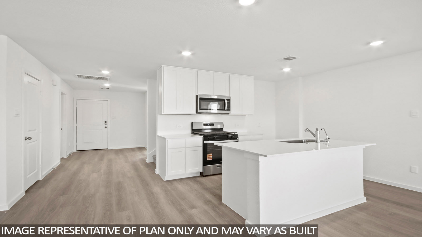 Denise kitchen with kitchen island with light cabinets and light countertops.